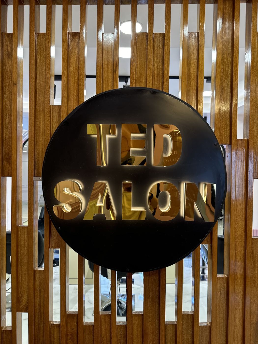 The gold Ted Salon sign that greets you at reception.