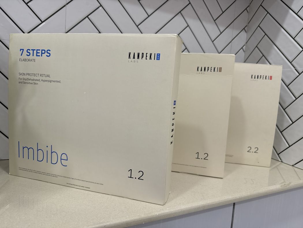 Kanpeki seven-step facial kits stacked on the counter of the treatment room.
